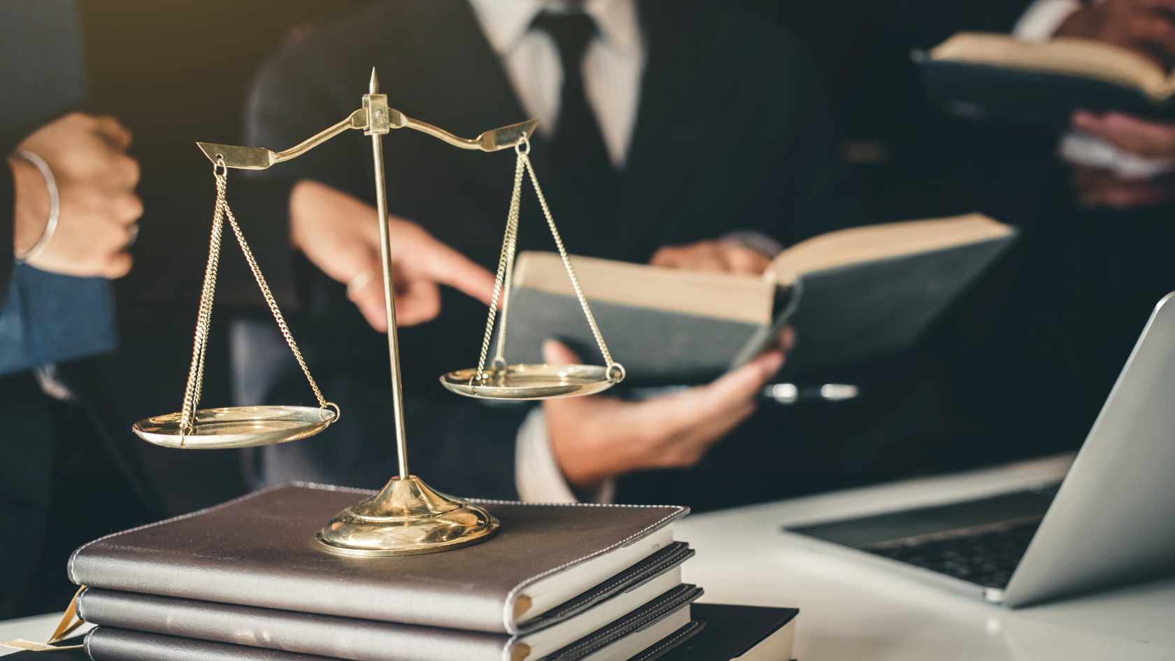 3 lawyers reading a book