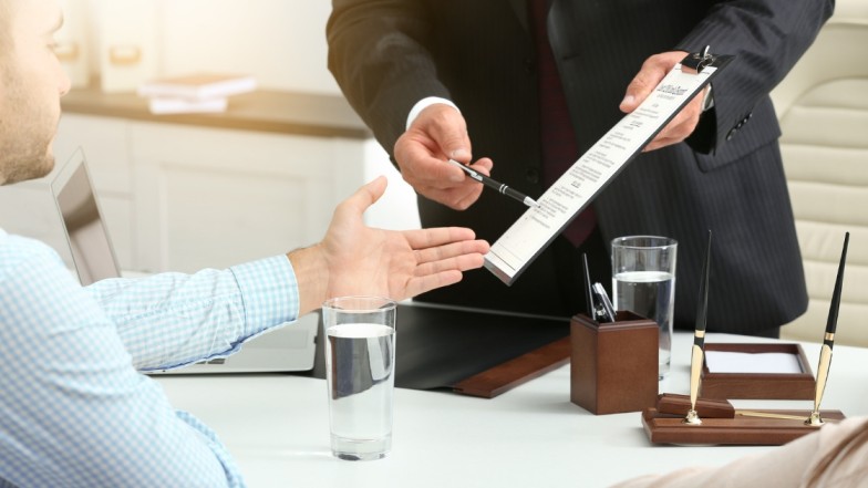 Car accident attorney explaining evidence documents to accident victim.