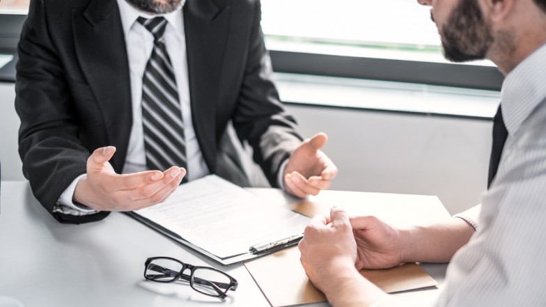 Accident attorney negotiating with insurance adjusters to counter false tactics