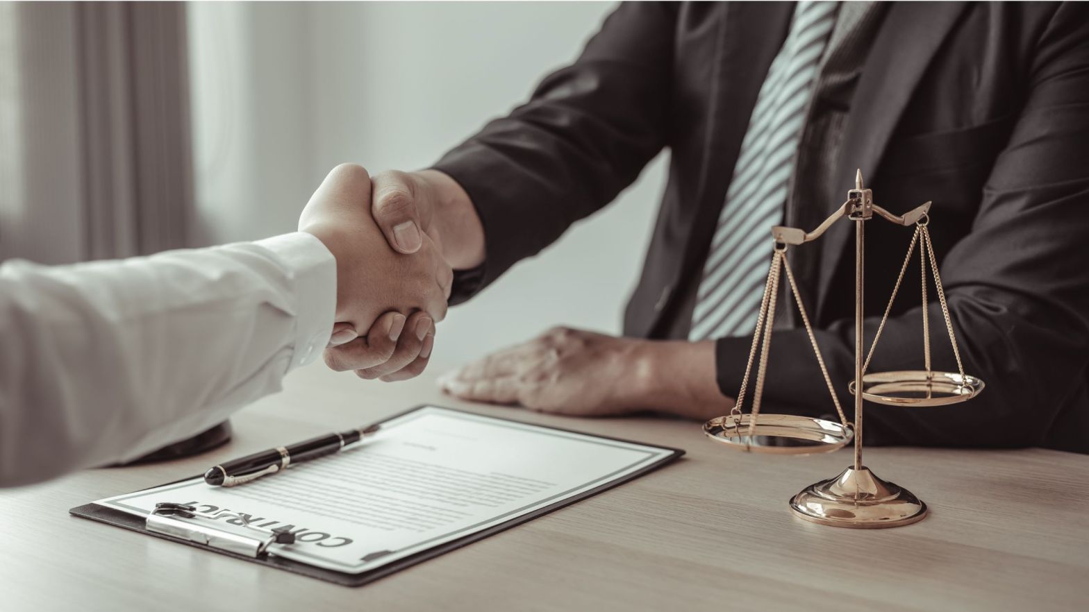 Lawyer and client signing a transparent written fee agreement for personal injury case
