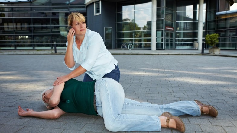 Person injured after slip and fall accident in New York, receiving medical help